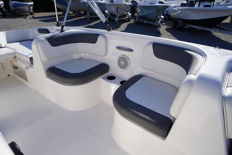 Slide: The Image of 2024 Bayliner Element E18 boat interior with cushioned seating and cup holders. - 6