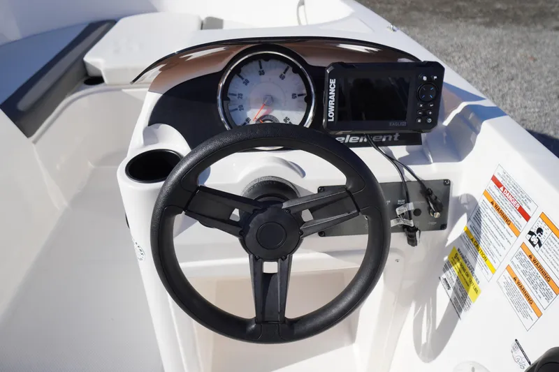 Slide: The Image of 2024 Bayliner Element E18 dashboard with steering wheel and navigation system. - 9