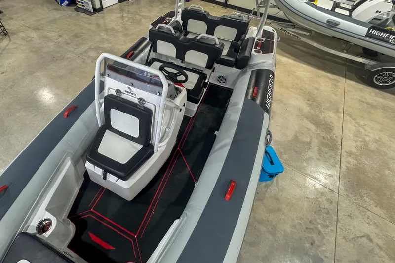 Slide: The Image of 2026 Highfield Velox 560 boat interior with modern seating and steering console. - 12