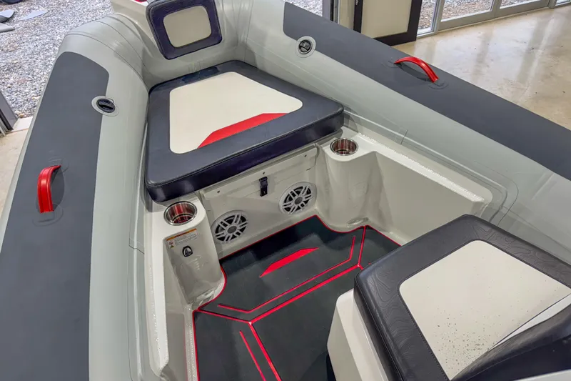 Slide: The Image of 2026 Highfield Velox 560 boat interior with seating, cup holders, and speakers. - 13