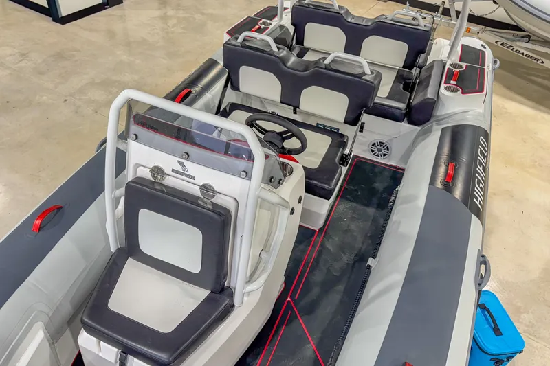 Slide: The Image of 2026 Highfield Velox 560 boat interior with seating and steering console. - 15