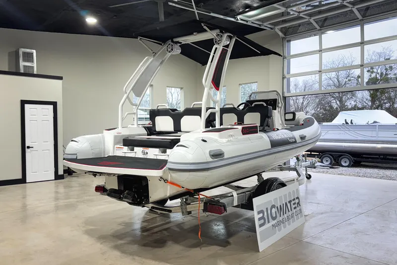 Slide: The Image of 2026 Highfield Velox 560 boat displayed indoors at Big Water Marine & Boat Club. - 7