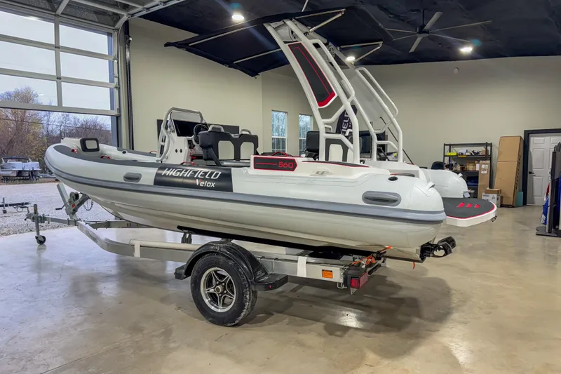 Slide: The Image of 2026 Highfield Velox 560 boat on trailer in a garage setting. - 9