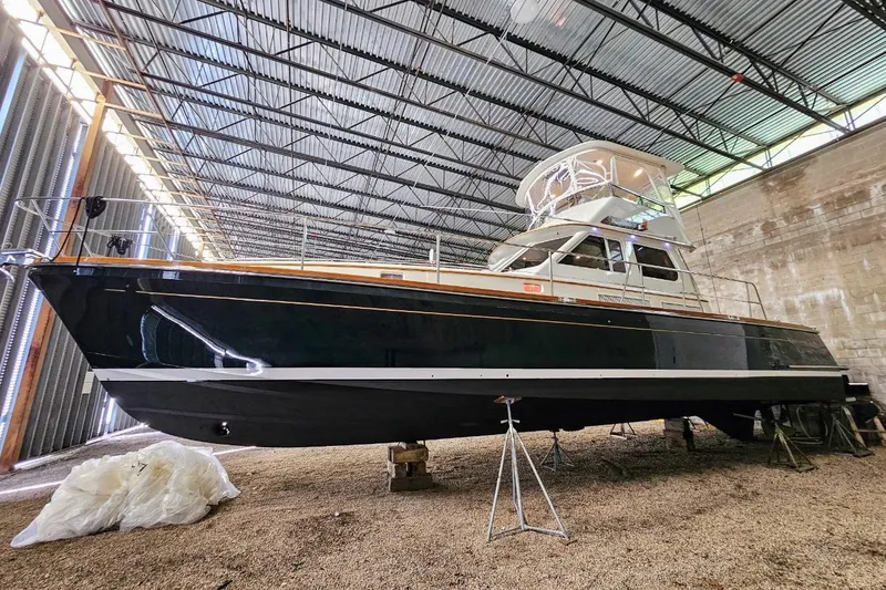 Slide: The Image of 2005 Alden 49 Flybridge Express Cruiser in a covered storage facility. - 10