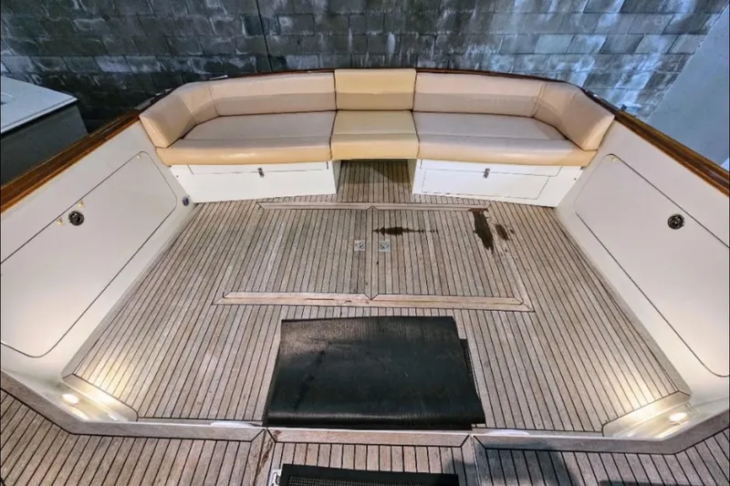 Slide: The Image of 2005 Alden 49 Flybridge Express Cruiser deck with cushioned seating and wooden flooring. - 11