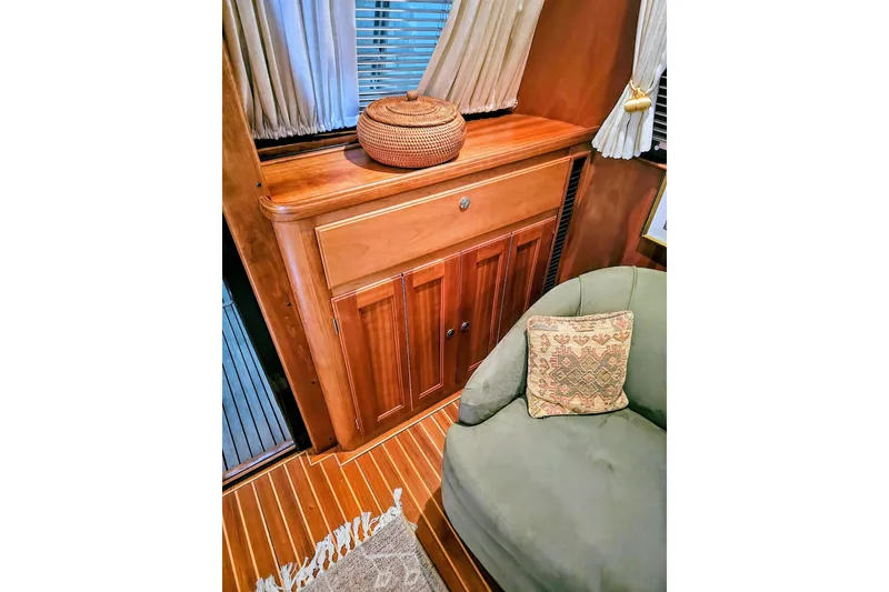 Slide: The Image of Interior of 2005 Alden 49 Flybridge Express Cruiser with wooden cabinetry and cozy seating. - 15
