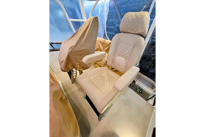 Slide: The Image of Luxurious seating on 2005 Alden 49 Flybridge Express Cruiser, featuring quilted upholstery. - 16