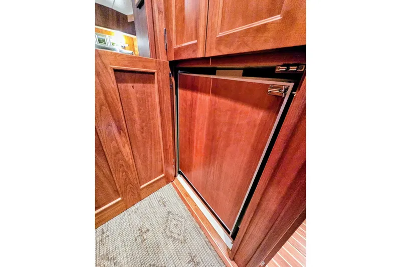 Slide: The Image of Wooden cabinetry in 2005 Alden 49 Flybridge Express Cruiser interior, showcasing elegant design. - 23