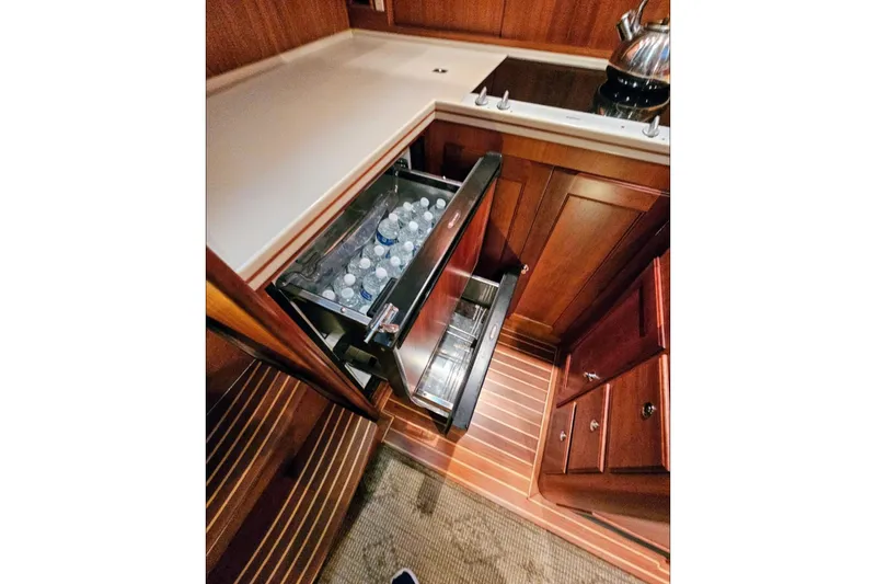 Slide: The Image of Galley of 2005 Alden 49 Flybridge Express Cruiser with open drawer fridge. - 24