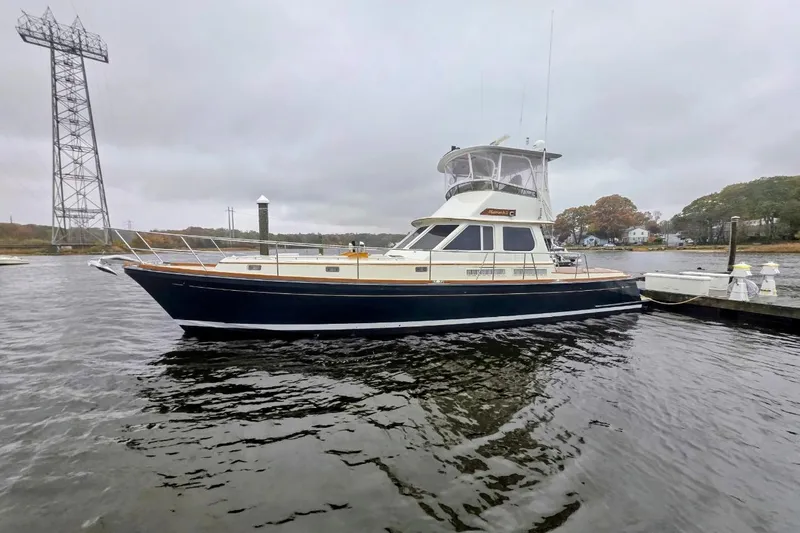 Slide: The Image of Alden 49 Flybridge Express Cruiser 2005 docked on a cloudy day. - 3