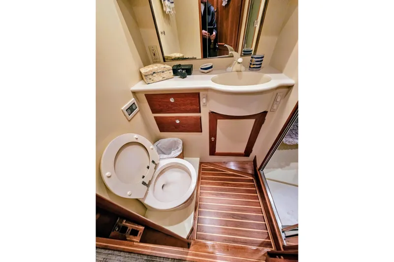 Slide: The Image of Luxurious bathroom in 2005 Alden 49 Flybridge Express Cruiser with wood accents and modern fixtures. - 31