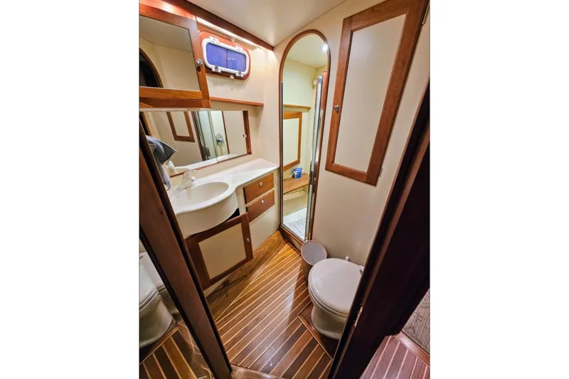 Slide: The Image of Luxurious bathroom in 2005 Alden 49 Flybridge Express Cruiser with wood accents and modern fixtures. - 33