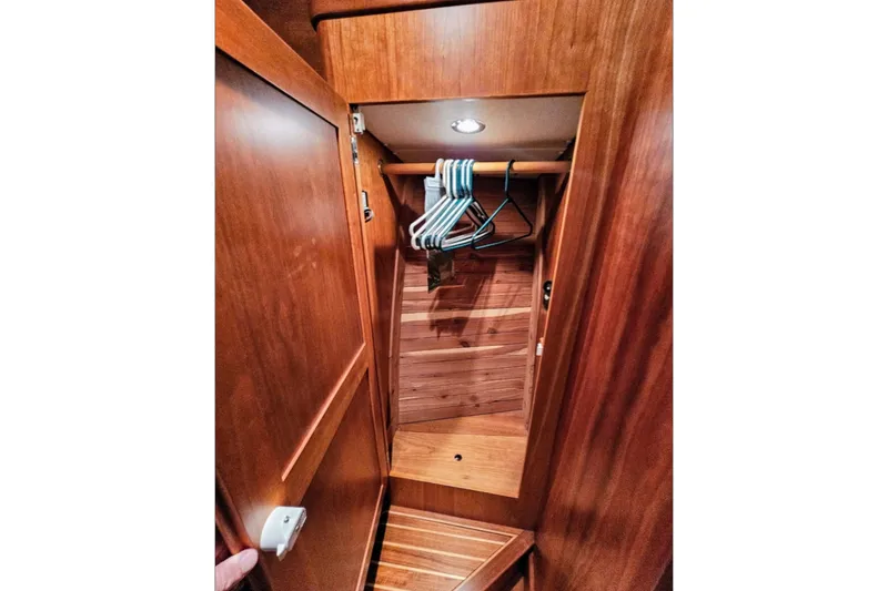 Slide: The Image of Wooden closet interior on 2005 Alden 49 Flybridge Express Cruiser with hangers. - 34