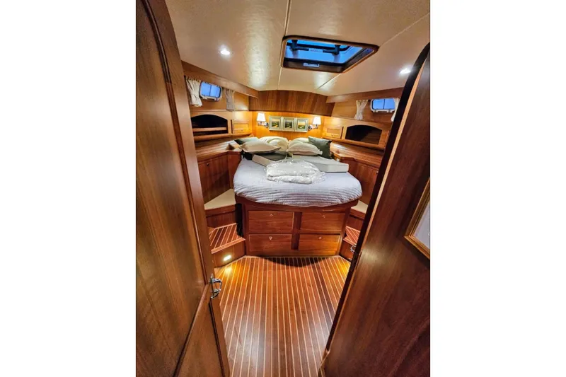 Slide: The Image of Luxurious cabin interior of 2005 Alden 49 Flybridge Express Cruiser with wood finish. - 37