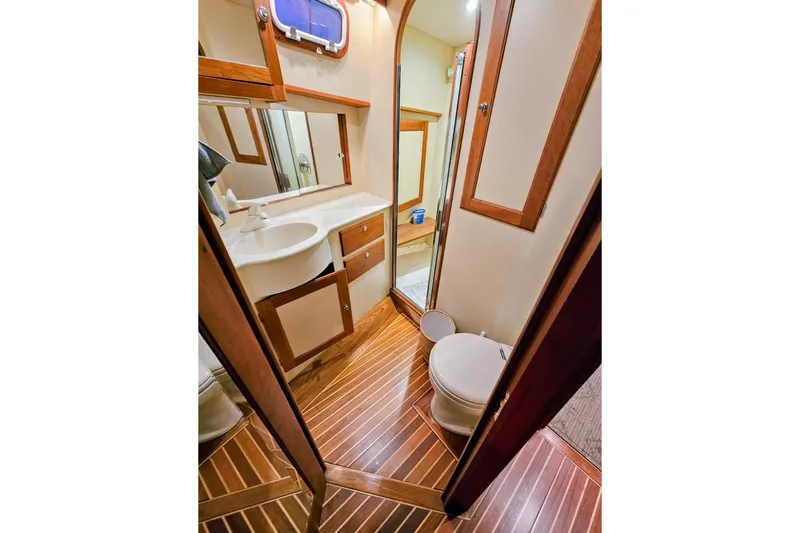 Slide: The Image of Luxurious bathroom in 2005 Alden 49 Flybridge Express Cruiser with wood accents and modern fixtures. - 42