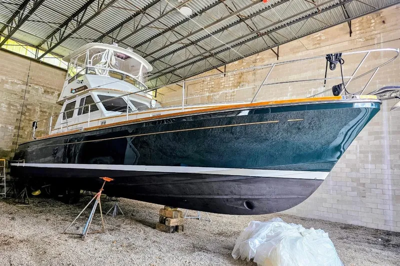 Slide: The Image of 2005 Alden 49 Flybridge Express Cruiser in a warehouse, showcasing sleek design and craftsmanship. - 6