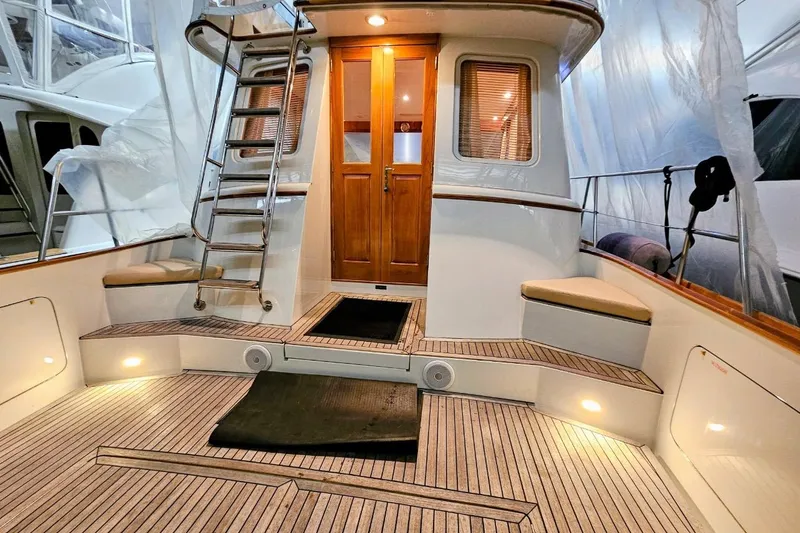 Slide: The Image of 2005 Alden 49 Flybridge Express Cruiser interior with wooden accents and seating. - 7