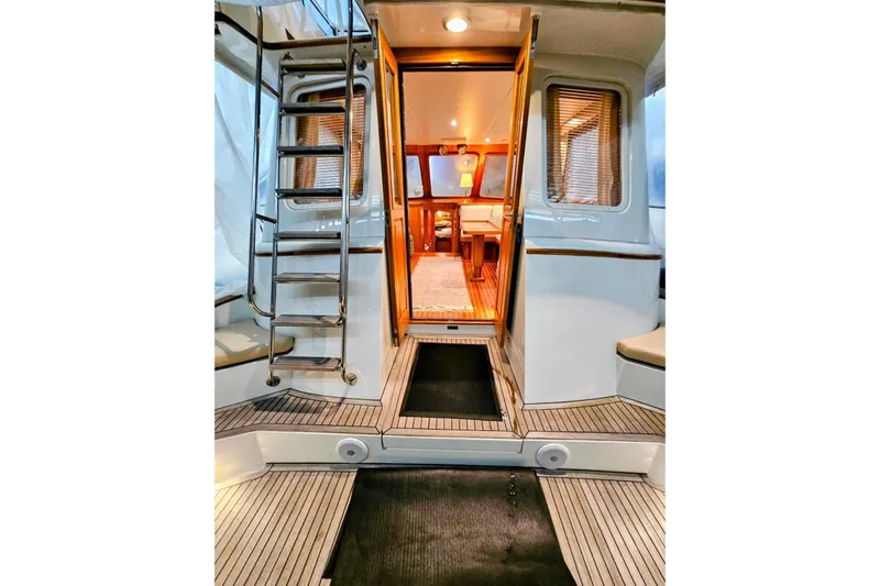 Slide: The Image of 2005 Alden 49 Flybridge Express Cruiser interior with ladder and seating area. - 8