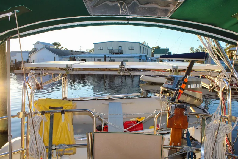 Slide: The Image of Cockpit view of 1990 Island Packet 32 sailboat with Yamaha motor at marina. - 16