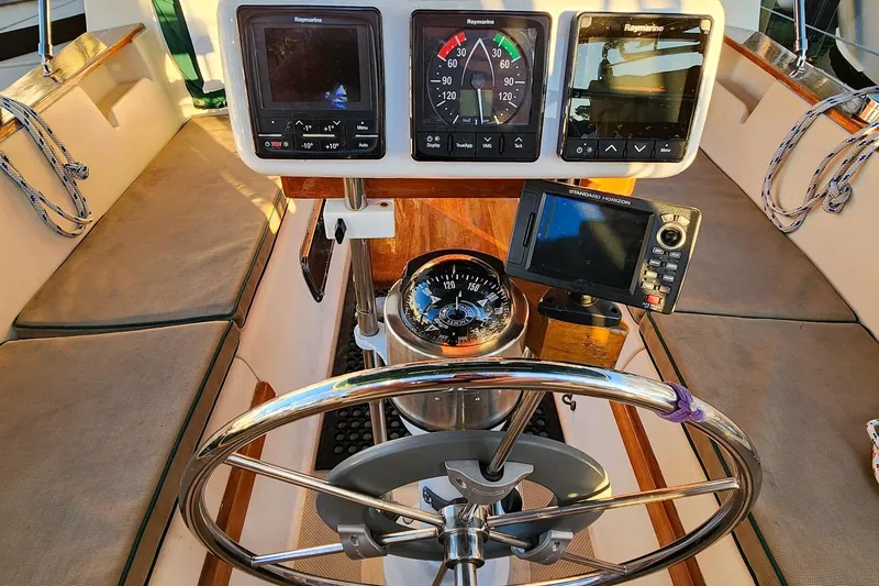 Slide: The Image of Cockpit of 1990 Island Packet 32 sailboat with navigation instruments and steering wheel. - 20