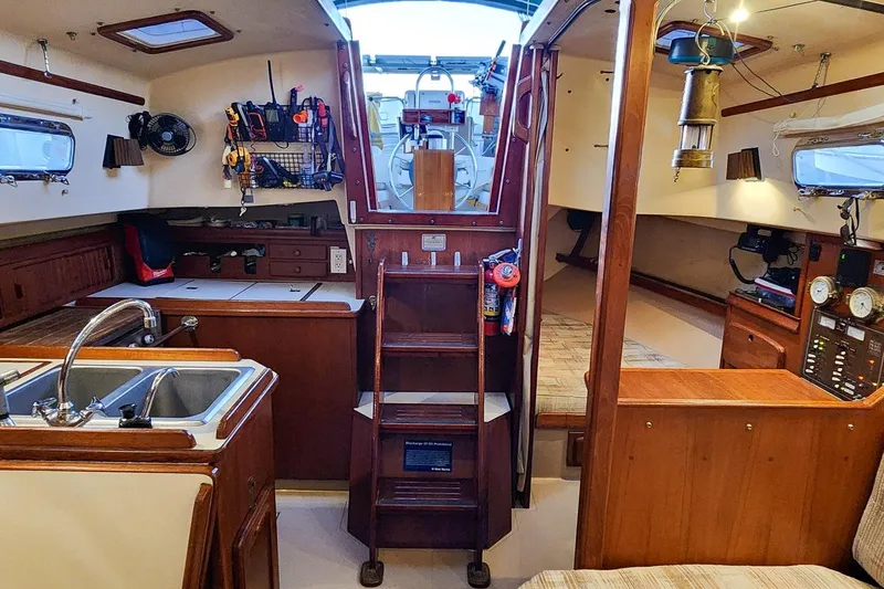Slide: The Image of Interior of 1990 Island Packet 32 sailboat with kitchen and navigation area. - 29