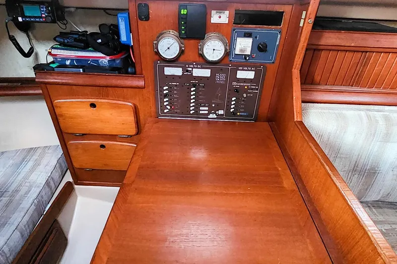Slide: The Image of 1990 Island Packet 32 sailboat interior with navigation station and control panel. - 43