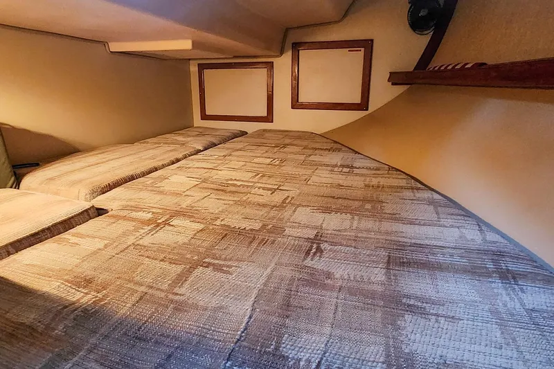 Slide: The Image of Cozy cabin interior of 1990 Island Packet 32 sailboat with patterned bedding. - 47