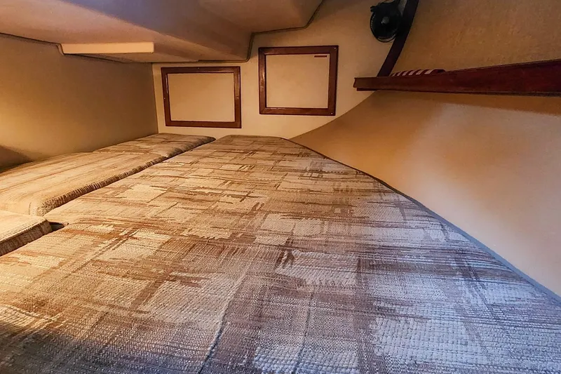 Slide: The Image of Interior cabin of 1990 Island Packet 32 sailboat with cozy bedding. - 48