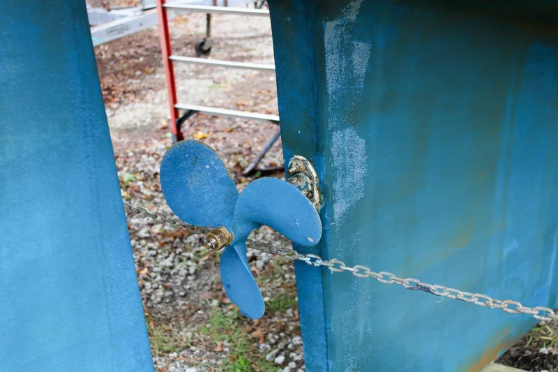Slide: The Image of Propeller of 1990 Island Packet 32 sailboat, blue-painted, on dry dock. - 51