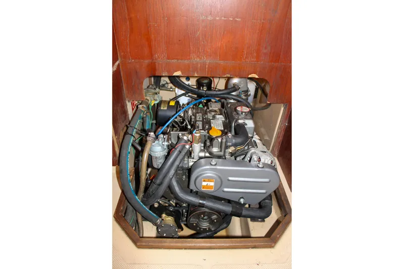 Slide: The Image of Engine compartment of a 1990 Island Packet 32 sailboat, showcasing mechanical components. - 57
