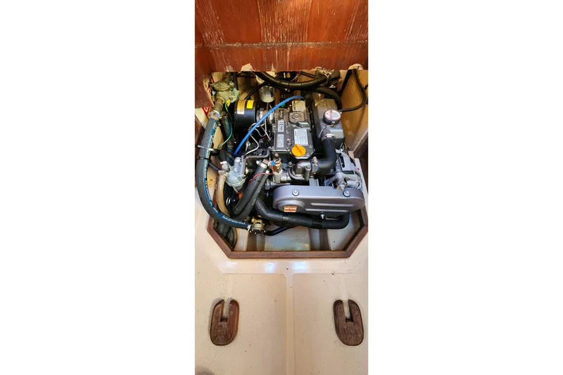 Slide: The Image of Engine compartment of a 1990 Island Packet 32 sailboat, showcasing detailed components. - 62