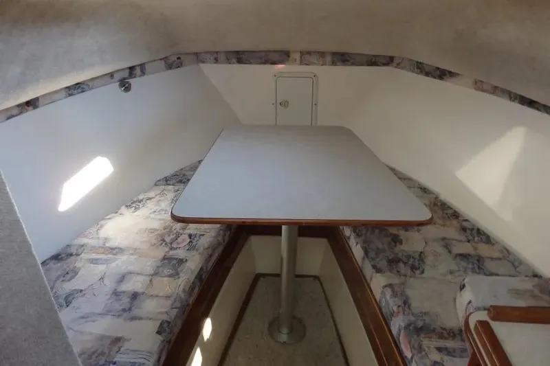 Slide: The Image of 2001 Shamrock 26 boat interior with table and cushioned seating. - 10
