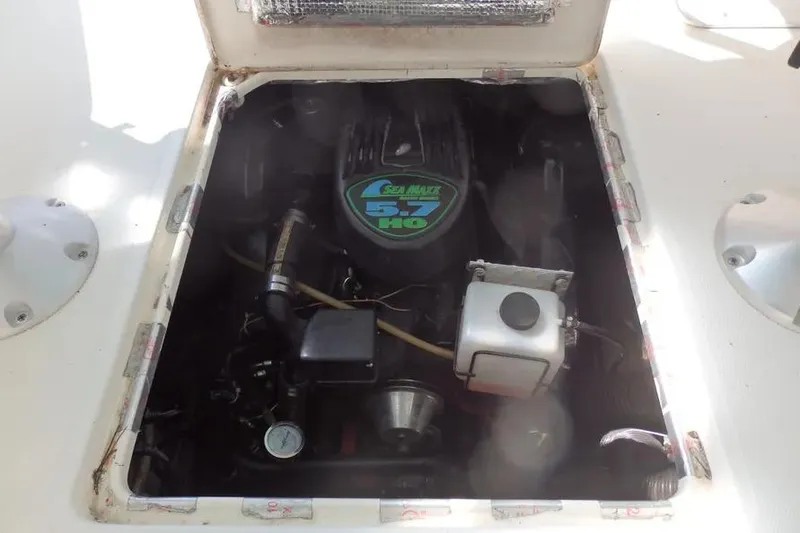 Slide: The Image of Engine compartment of a 2001 Shamrock 26 boat, featuring a Sea Maxx 5.7 HO engine. - 13