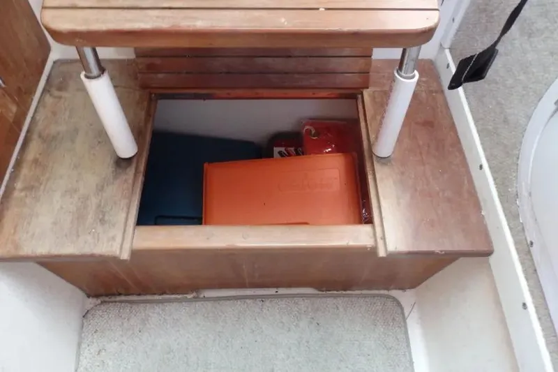 Slide: The Image of Storage compartment under wooden steps on a 2001 Shamrock 26 boat. - 15