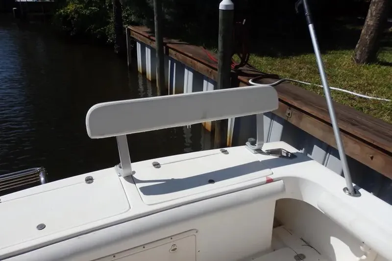 Slide: The Image of 2001 Shamrock 26 boat with white seating near a dock. - 17