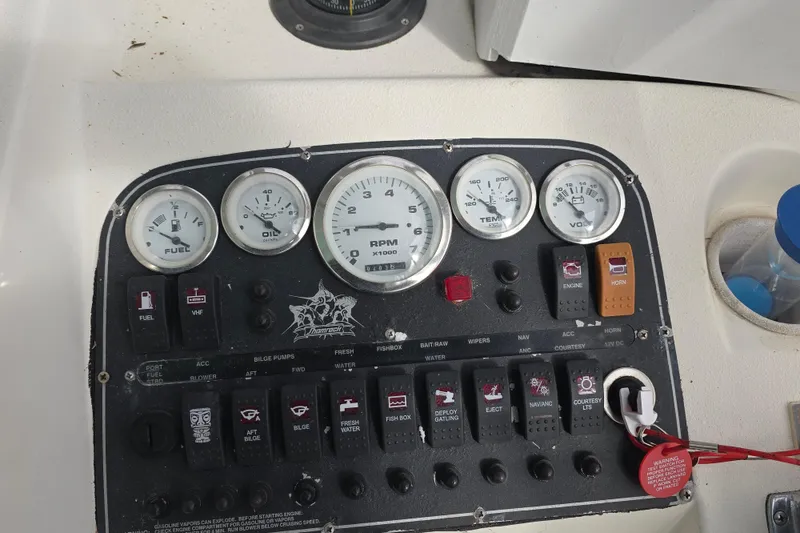 Slide: The Image of Control panel of a 2001 Shamrock 26 boat with gauges and switches. - 7