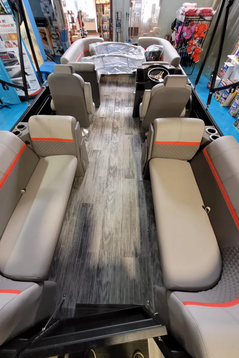 Slide: The Image of 2023 Qwest RLS 822 pontoon boat interior with gray seating and red accents. - 14