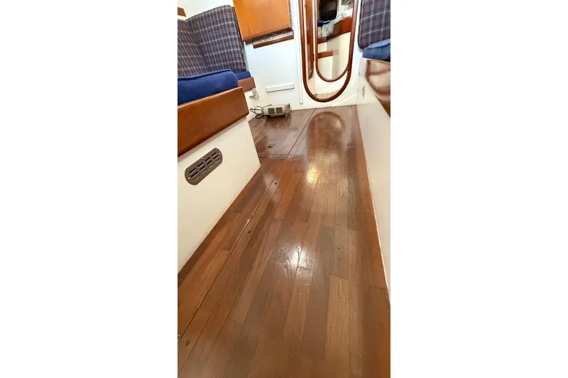 Slide: The Image of Interior of 1975 Cascade 36 sailboat with polished wooden flooring. - 11