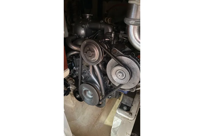 Slide: The Image of 1975 Cascade 36 engine with visible belts and pulleys in a boat compartment. - 18