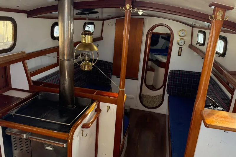 Slide: The Image of Interior of a 1975 Cascade 36 sailboat with wood accents and vintage decor. - 2