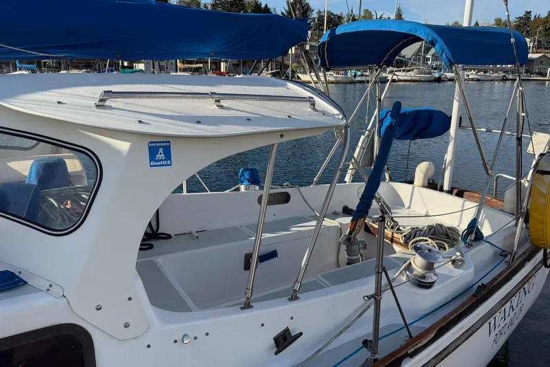 Slide: The Image of 1975 Cascade 36 sailboat with blue canopy docked at marina. - 20