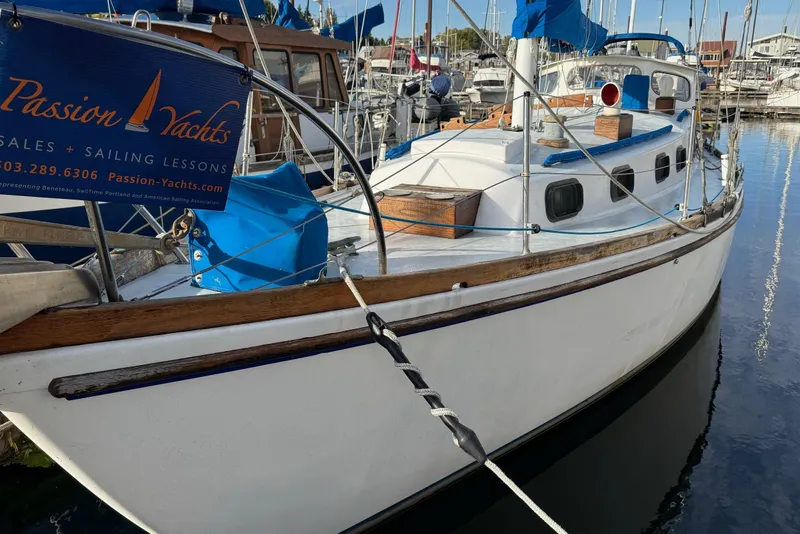 Slide: The Image of 1975 Cascade 36 sailboat docked, featuring Passion Yachts signage and marina background. - 28