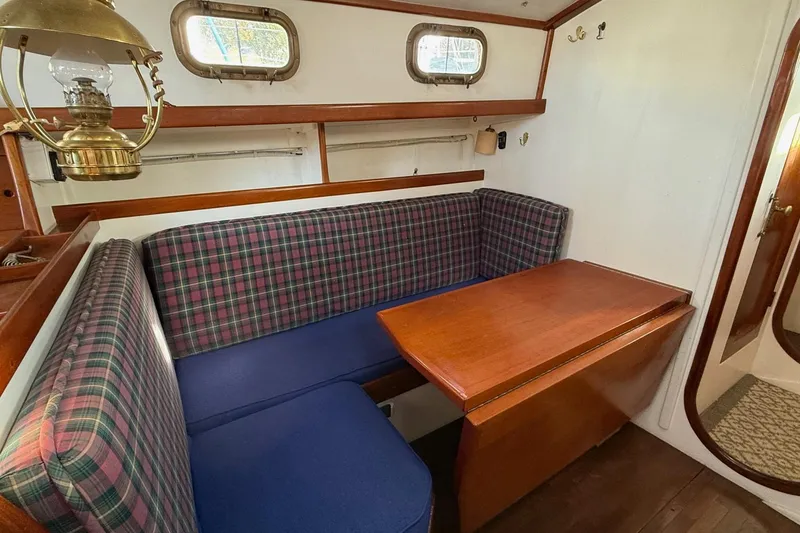 Slide: The Image of Vintage 1975 Cascade 36 sailboat interior with plaid seating and wooden table. - 5