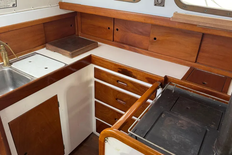 Slide: The Image of 1975 Cascade 36 yacht kitchen with wooden cabinets and stainless steel sink. - 7