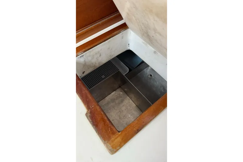 Slide: The Image of 1975 Cascade 36 interior compartment with wooden trim and metal storage space. - 9