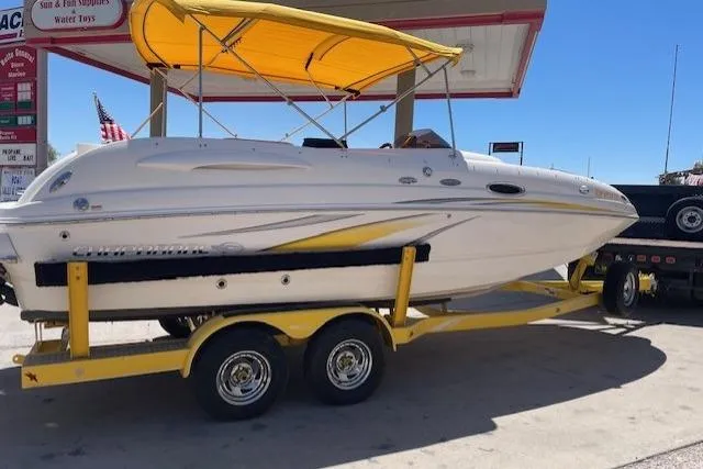 The Image of 2007 Chaparral Sunesta 232 boat on yellow trailer at a gas station. - 0