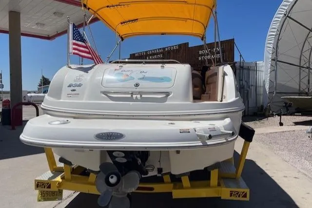 Slide: The Image of 2007 Chaparral Sunesta 232 boat with yellow canopy on trailer at marina. - 2