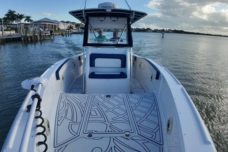 Slide: The Image of 2000 Donzi 35 boat cruising on calm waters, featuring a stylish deck and seating area. - 10