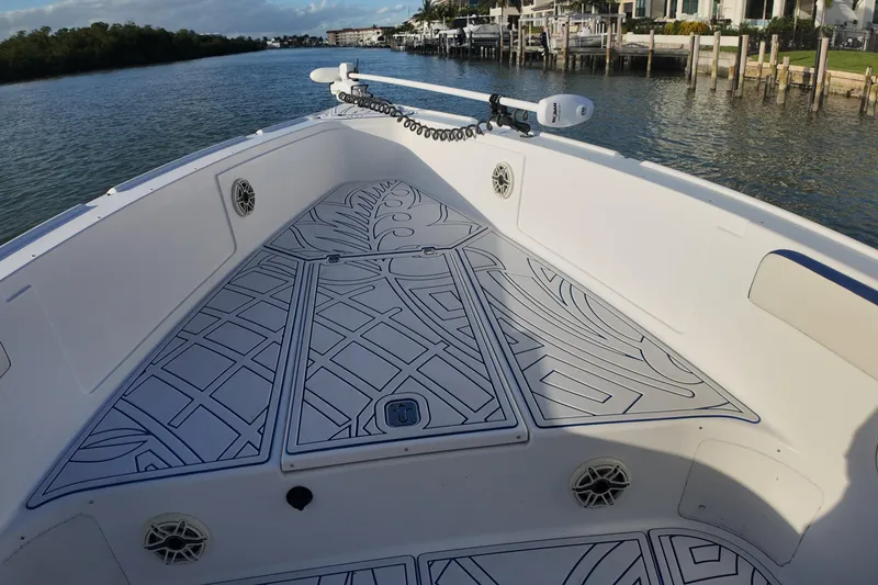 Slide: The Image of 2000 Donzi 35 boat deck with custom non-slip flooring, docked by a scenic waterfront. - 12