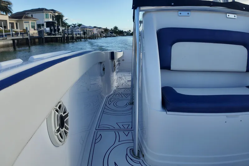 Slide: The Image of 2000 Donzi 35 boat interior with blue and white seating, dockside view. - 17